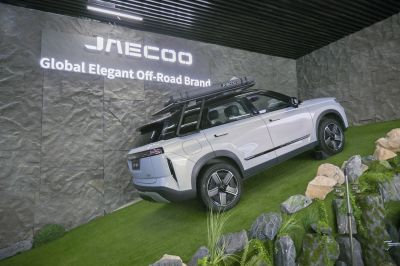 Off-road SUV with roof tent on grassy slope