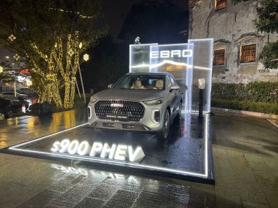 Front view of SUV with illuminated grille and LED headlights at night.