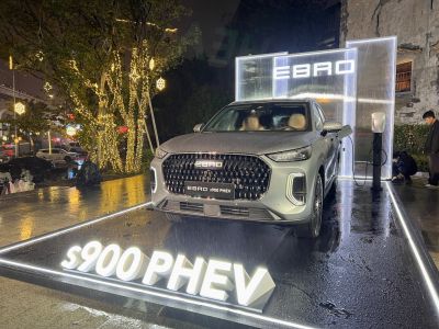 Front view of SUV with bold grille and charging port