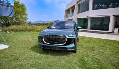 Front view with large mesh grille and vertical LED headlights