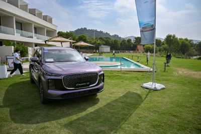Front view of modern SUV with large patterned grille and LED lights