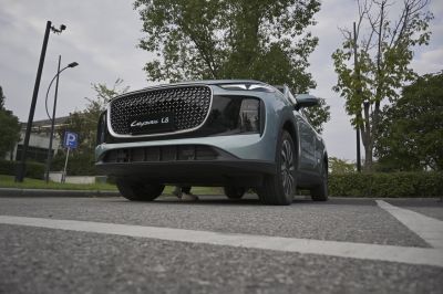 Low-angle view of SUV front with patterned grille and sleek headlamps