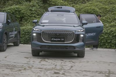 Front view with large geometric grille and slim LED headlights.