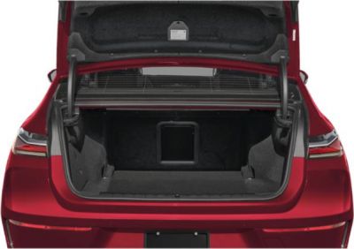 Open spacious rear trunk of an electric luxury sedan.