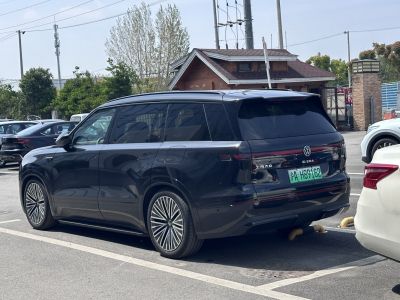 Rear and side view of vehicle with continuous taillight strip and stylish alloy wheels.