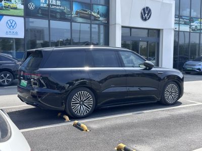Sleek black electric SUV parked showing side and rear with tinted windows and modern wheels
