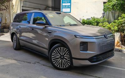 Sleek front-side view of electric SUV with aerodynamic design and stylized alloy wheels