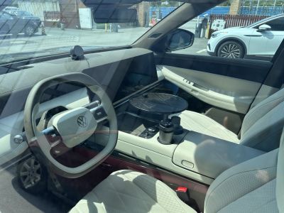 Minimalist steering wheel and futuristic dashboard in a modern electric vehicle interior
