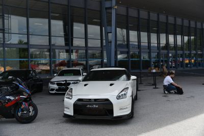 White sports car front view with vented hood and aggressive headlights