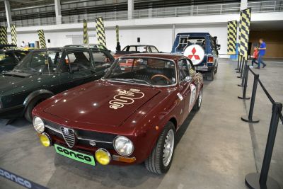 Front view of vintage sports coupe with round headlights and racing decals