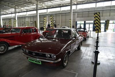 Vintage sports coupe with round headlights and black grille.