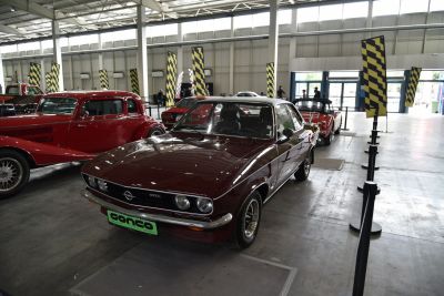 Sleek vintage coupe with distinctive dual headlight front grille