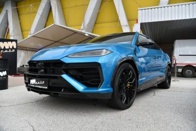 Blue SUV front with sleek headlights and black alloy wheels