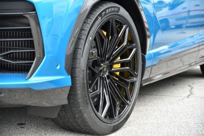 Close-up of black alloy wheel and yellow brake caliper with Pirelli tire