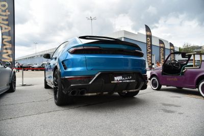 Rear view of luxury SUV with carbon fiber diffuser and quad exhaust