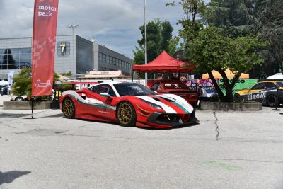 Racing car with vibrant red-white-green racing livery and large aerodynamic wing