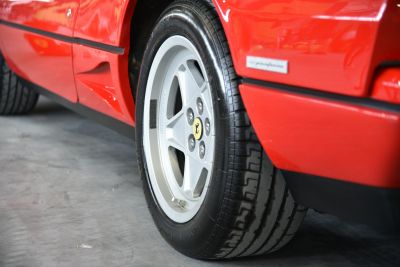 Alloy wheel with Pirelli tire on red car body panel