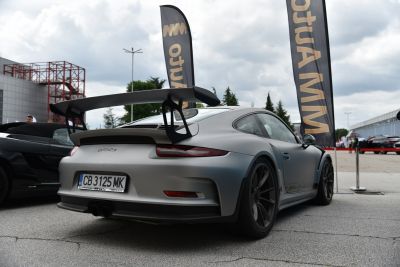 Rear view with large fixed spoiler and wide body design