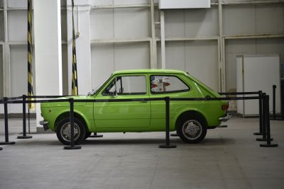 Compact vintage hatchback in lime green with stickers on window