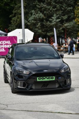 Front view of aggressive sporty hatchback with large grille and sleek headlights