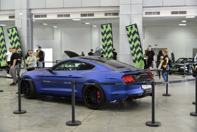Matte blue sports coupe with black alloy wheels and red brake calipers