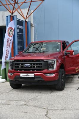 Front view of red pickup truck with grille and headlights