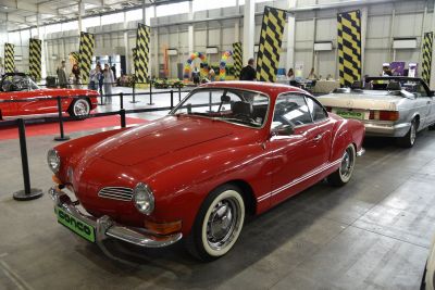 Vintage red coupe with rounded headlights and chrome bumper