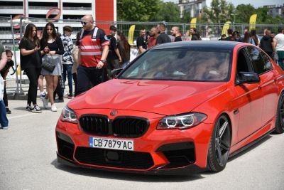 Red sedan front with LED headlights and black kidney grille