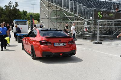 Lowered sedan rear with black roof, quad exhausts and custom spoiler