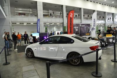 White coupe with bronze aftermarket wheels and tinted windows