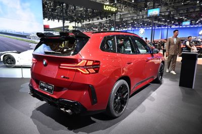Rear view with quad exhausts, sporty spoiler, black wheels, and LED taillights