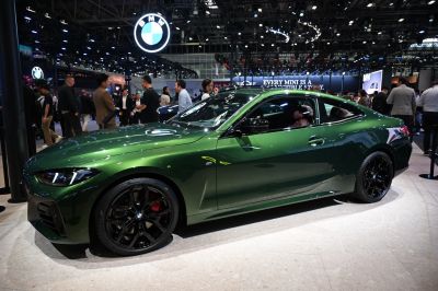 Sleek metallic green coupe with black alloy wheels