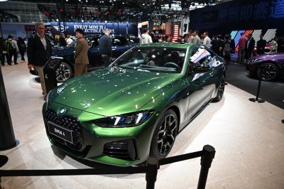 Sporty coupe front view with aggressive grille and black alloy wheels