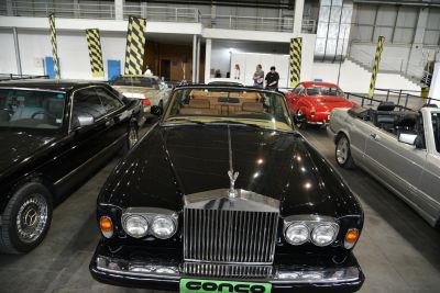 Luxury classic convertible front view with iconic grille and dual round headlights.