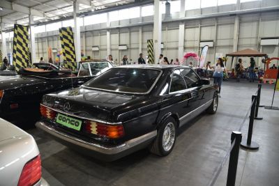 Rear view of a classic black coupe with distinctive taillights and chrome trim