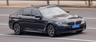 Sleek front side view with kidney grille and sporty wheels