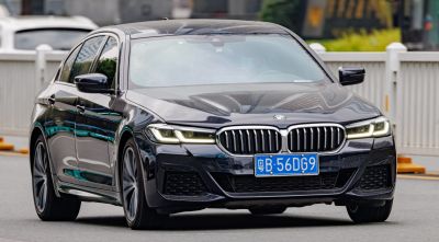 Facelifted luxury sedan front view with signature kidney grille and LED headlights