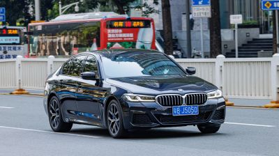 Luxury sedan front view with LED headlights and kidney grille