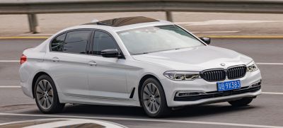 Luxury sedan with sunroof and alloy wheels in motion