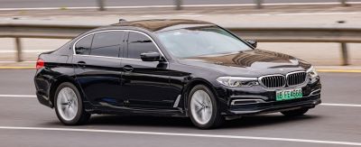 Black sedan with front-side view, alloy wheels, aerodynamic design