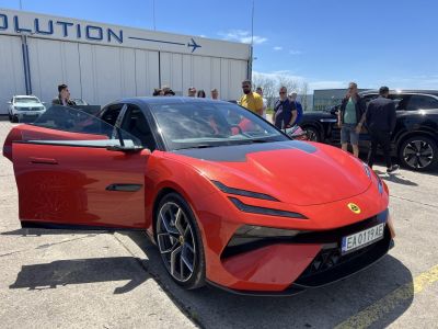Electric sports sedan with sleek front, aerodynamic design, and premium alloy wheels