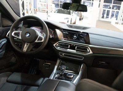 Modern 2020 BMW X6 interior with digital dashboard and steering wheel controls