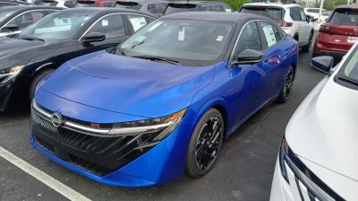 Front and side view of blue sedan with sleek headlights and black alloy wheels