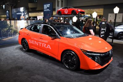 Orange Nissan Sentra IX (B19) with black accents and sporty wheels