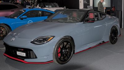 Front-side view of a sleek sports coupe with black rims and aerodynamic accents