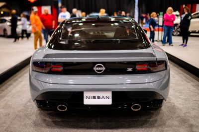 Rear view of a sporty coupe with distinctive tail lights and dual exhausts