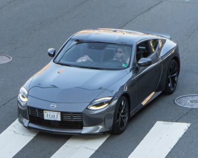 High-angle front-side view of a sleek sports coupe with LED headlights