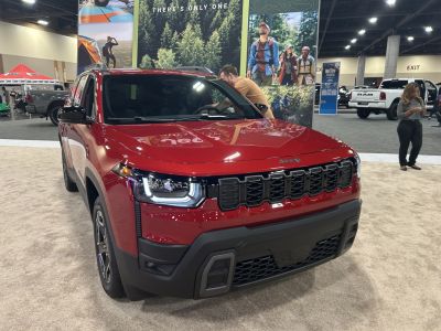 Front view with LED headlights and distinctive grille in red