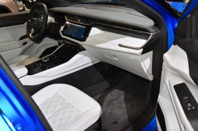 Modern SUV interior with white leather seats and touchscreen dashboard