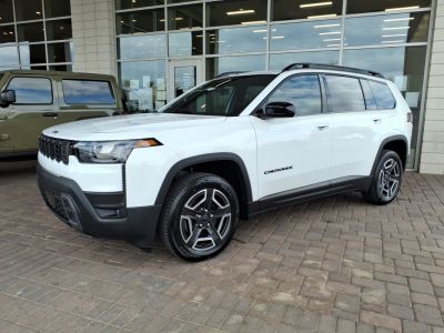 Front and side profile of a white SUV with sleek headlights and alloy wheels